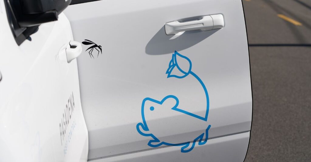 A white vehicle door features a blue graphic of a mouse and a small insect illustration in pest-control-vehicle.